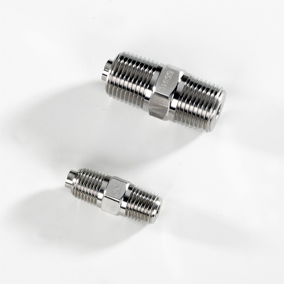 Two hex weld fittings with the weld lip visible