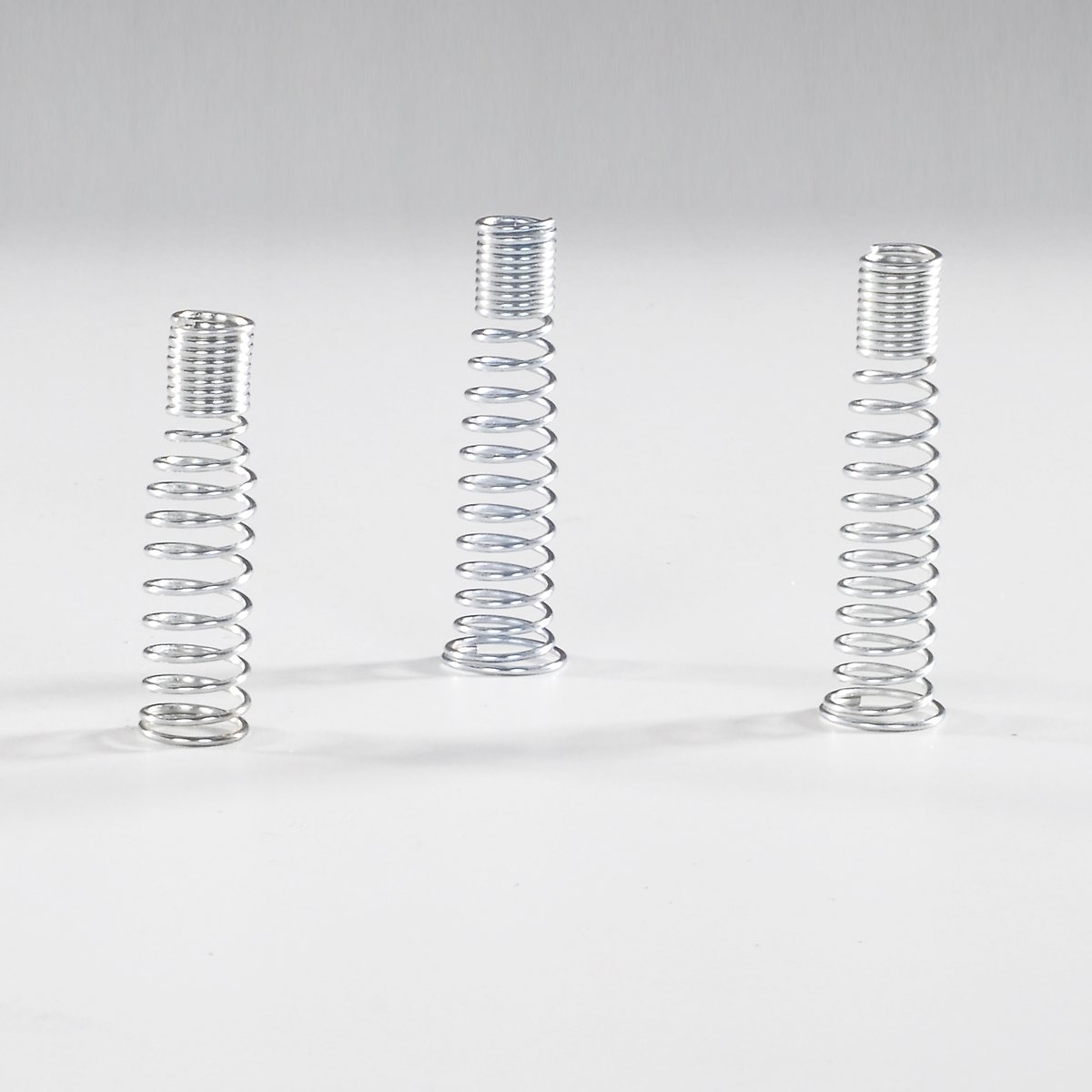 Compression springs for spring loaded fittings