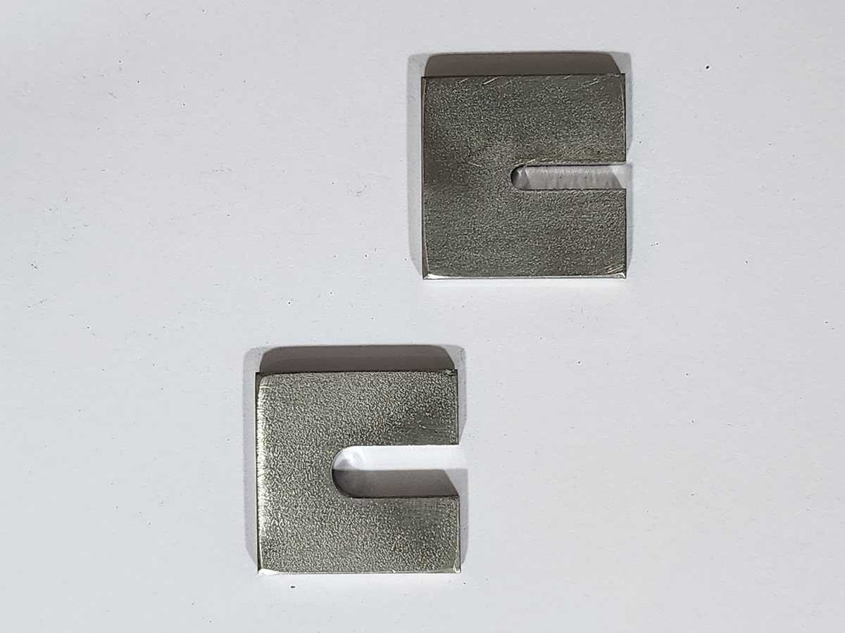 Two stainless steel weld pads with a slot for the probe